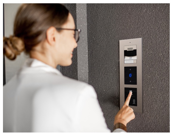 Person entering a PIN on a 2N access control keypad