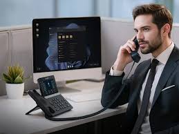 Professional on a call at a Yealink IP desk phone